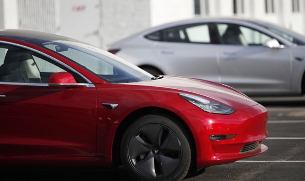 In this Sunday, May 27, 2018, photo a pair of 2018 Model 3's sit at a Tesla dealership in Littleton, Colo. A wireless update of antilock braking software improved the stopping distance of Tesla's electric Model 3, prompting Consumer Reports to reverse course and give the car its "Recommended Buy" rating. The magazine said Wednesday, May 30, that the update cut 19 feet off the car's stopping distance from 60 miles per hour. (AP Photo/David Zalubowski)