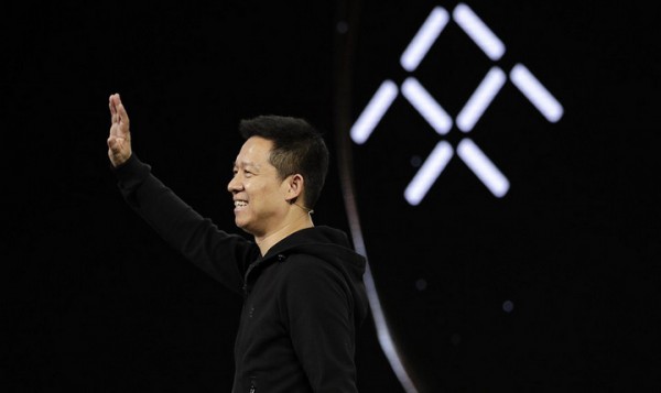 LeEco CEO YT Jia waves during the unveiling of Faraday Future's FF91 electric car at CES International Tuesday, Jan. 3, 2017, in Las Vegas. (AP Photo/Jae C. Hong)
